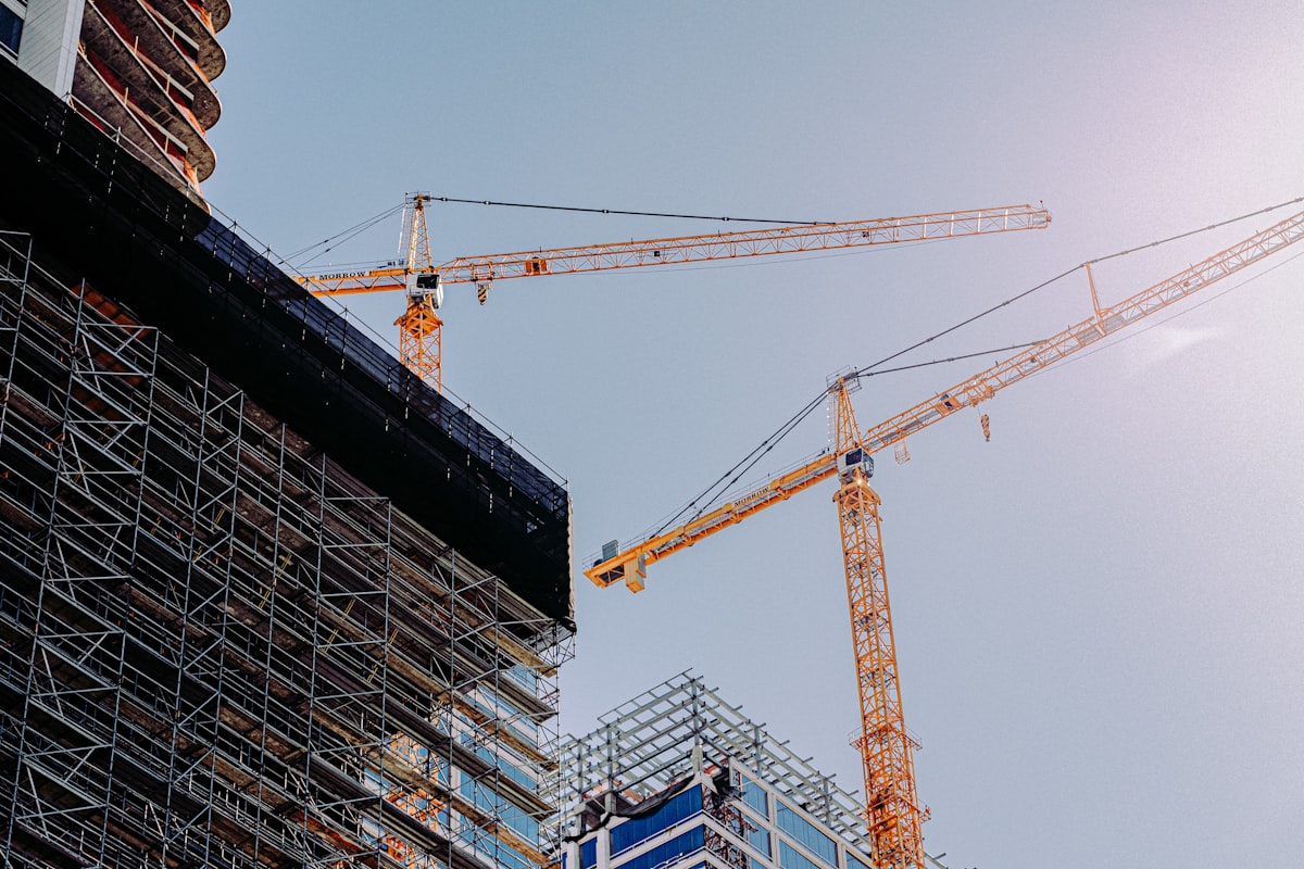 Building exterior with crane during construction, daytime