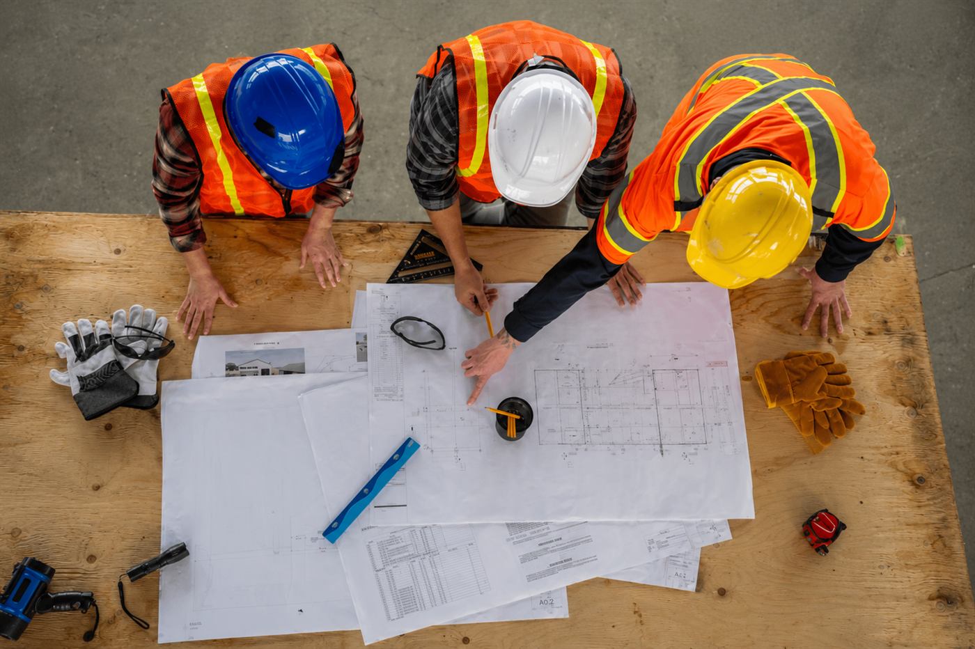 Construction team reviewing site drawings from above